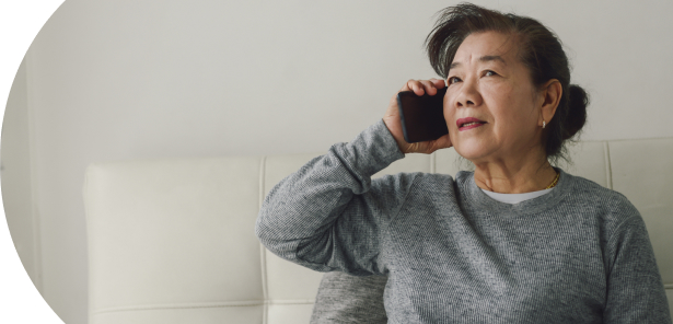 Woman sitting on sofa, talking on the phone
