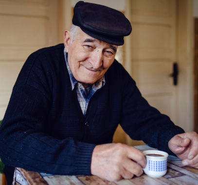 Senior man smiling and drinking coffee